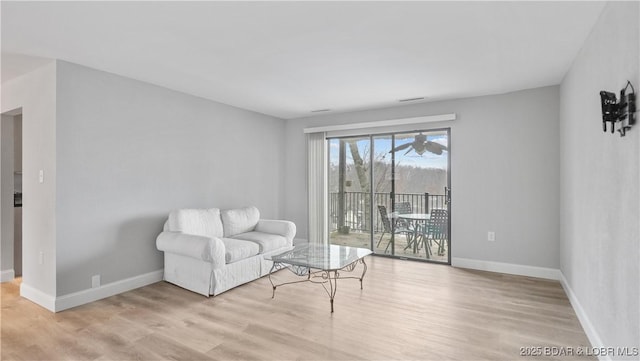 living area with light hardwood / wood-style flooring