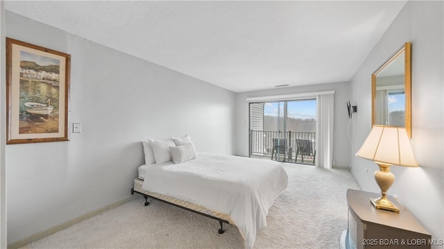 bedroom featuring light colored carpet and access to exterior