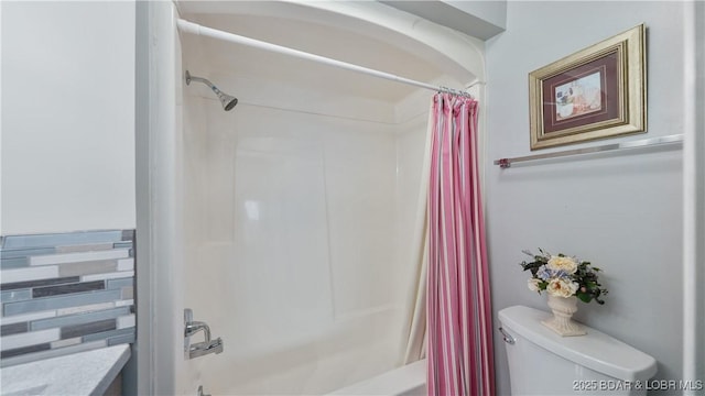 bathroom featuring shower / bath combo and toilet