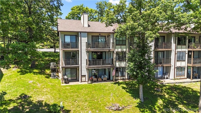 rear view of property with a yard