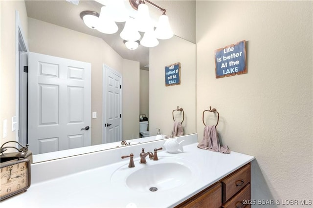 27112 White Horse Cir, Rocky Mount, MO 65072 - bathroom featuring vanity, a chandelier, and toilet