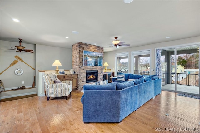 27112 White Horse Cir, Rocky Mount, MO 65072 - living room with ceiling fan, light wood-type flooring, a fireplace, and recessed lighting