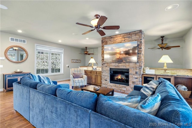 27112 White Horse Cir, Rocky Mount, MO 65072 - living room with ceiling fan, light wood-style flooring, a fireplace, recessed lighting, and baseboards