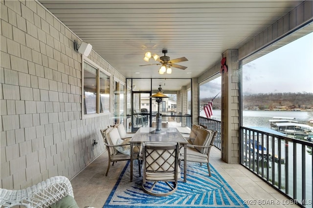 27112 White Horse Cir, Rocky Mount, MO 65072 - sunroom with tile patterned floors, ceiling fan, outdoor dining space, and tile walls