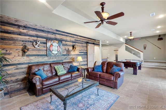 27112 White Horse Cir, Rocky Mount, MO 65072 - living room featuring wood walls, a ceiling fan, a barn door, billiards table, and light tile patterned floors