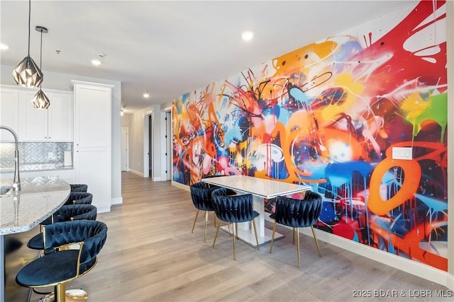 game room featuring recessed lighting, light wood-type flooring, and baseboards