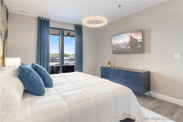 bedroom featuring light wood-style floors, baseboards, visible vents, and access to exterior