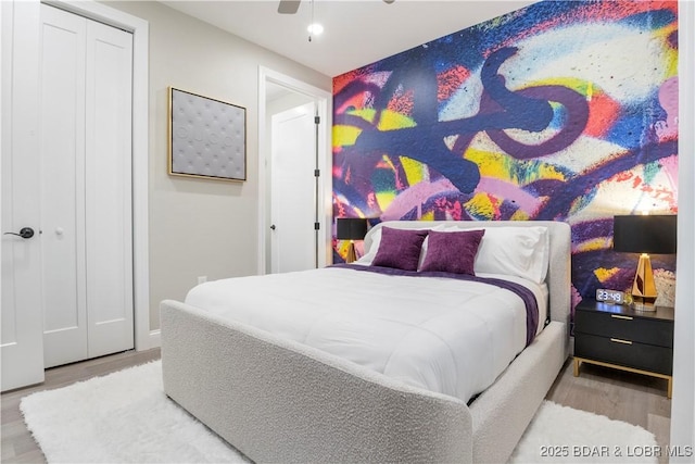 bedroom with a ceiling fan and wood finished floors