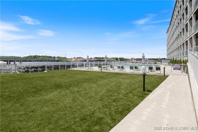 exterior space with a water view and fence