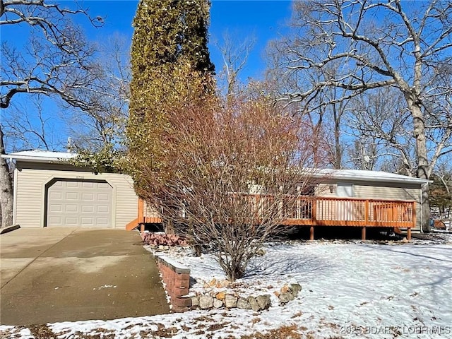 view of front of property with a wooden deck and a garage