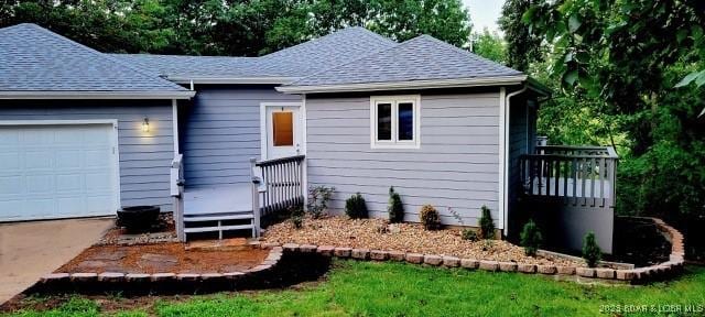 view of front facade with a garage and a deck