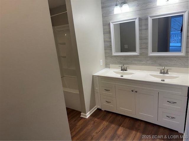 bathroom featuring vanity, hardwood / wood-style floors, and shower / tub combination