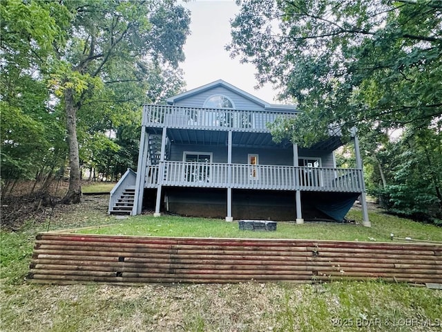 rear view of property featuring a yard and a deck