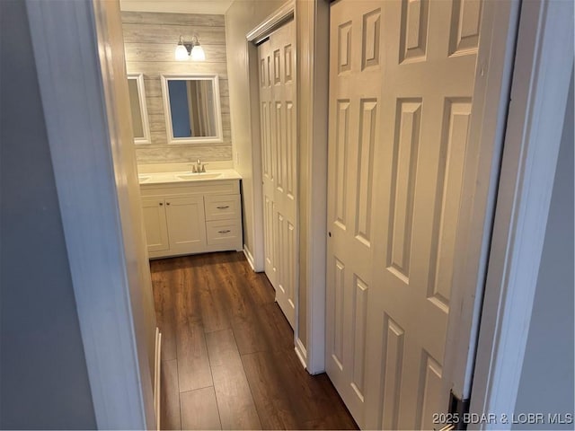 hall with dark hardwood / wood-style floors and sink