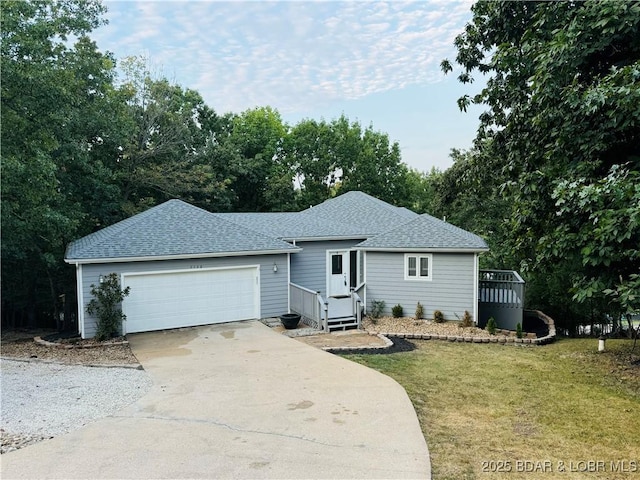 ranch-style house featuring a garage and a front lawn