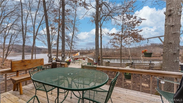 wooden terrace featuring a water view