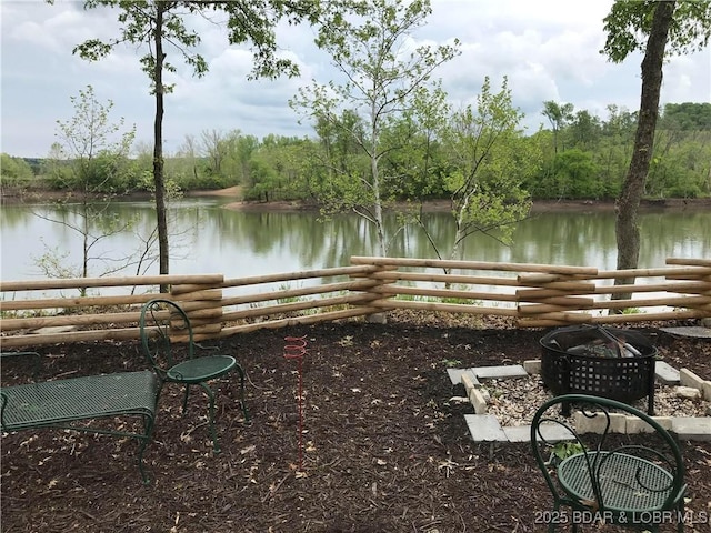 view of yard with a water view and a fire pit