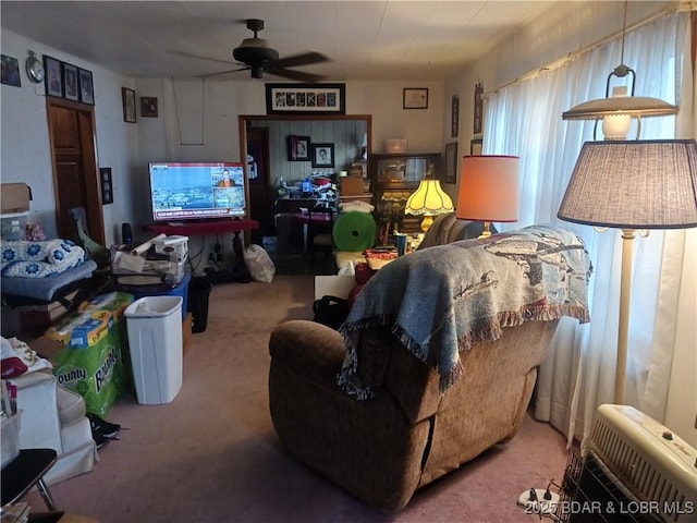 carpeted living room with ceiling fan