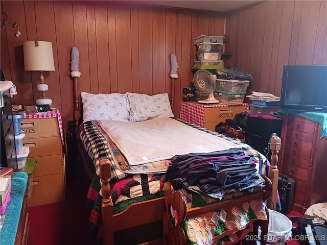 bedroom featuring wood walls