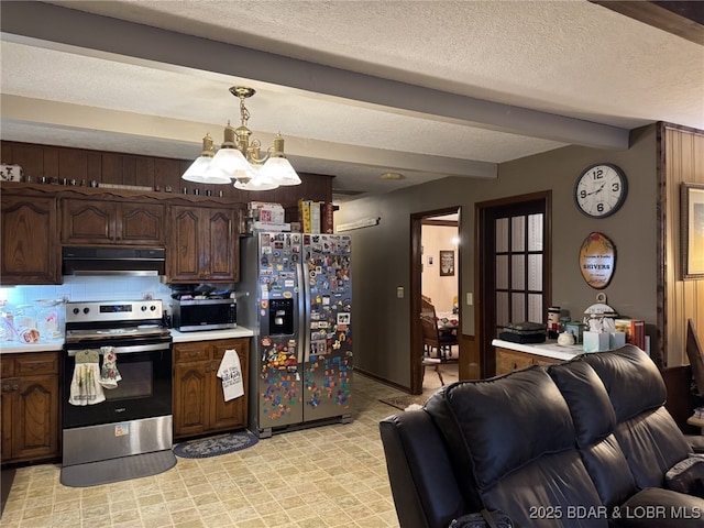 kitchen with dark brown cabinetry, light countertops, appliances with stainless steel finishes, ventilation hood, and hanging light fixtures