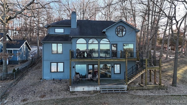 back of house featuring a wooden deck