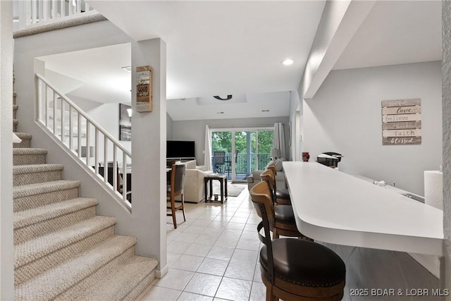 dining space featuring stairs, light tile patterned floors, and recessed lighting