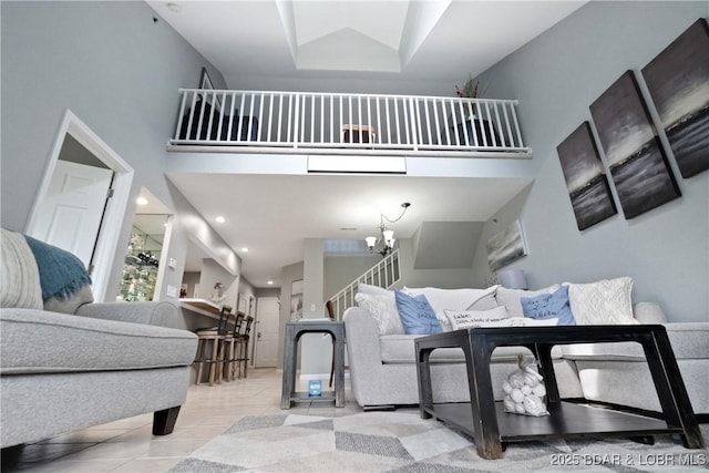 living room with recessed lighting, a towering ceiling, an inviting chandelier, light tile patterned flooring, and stairs