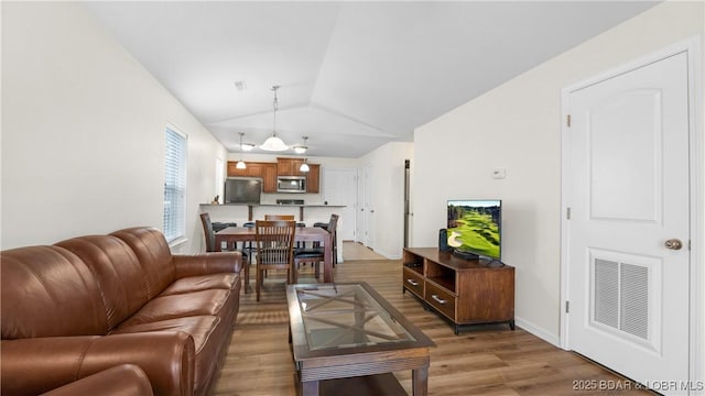 living room with lofted ceiling and hardwood / wood-style floors