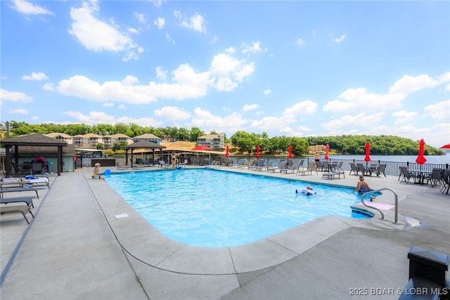 view of swimming pool featuring pool water feature, a patio, and a gazebo