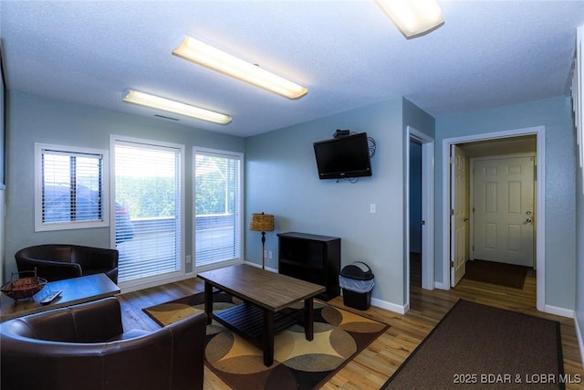 living room with hardwood / wood-style floors and a textured ceiling