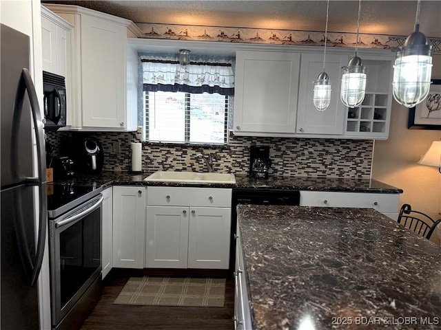 kitchen featuring white cabinetry, pendant lighting, sink, and stainless steel electric range