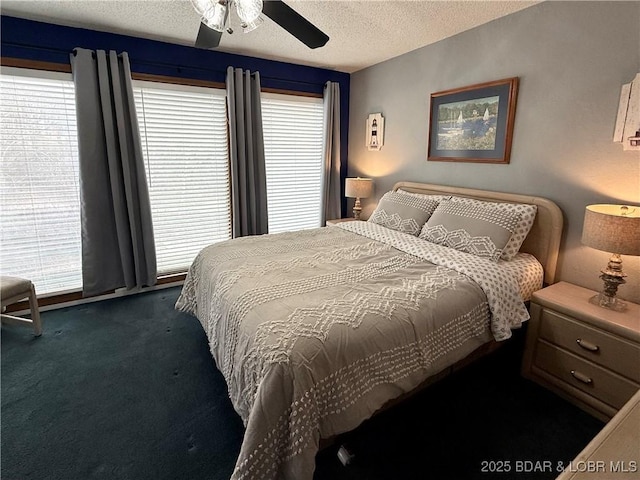 carpeted bedroom with ceiling fan and a textured ceiling