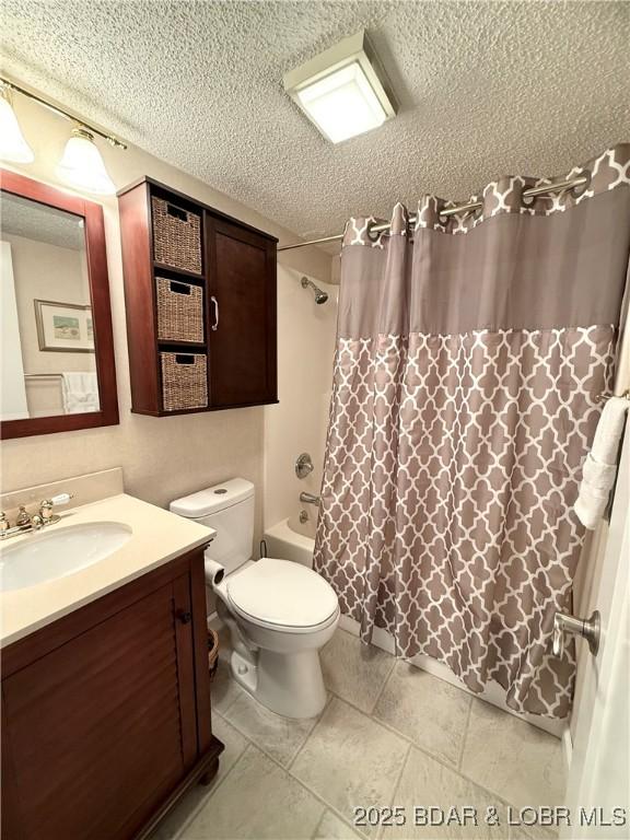 full bathroom with a textured ceiling, toilet, shower / bath combination with curtain, and vanity