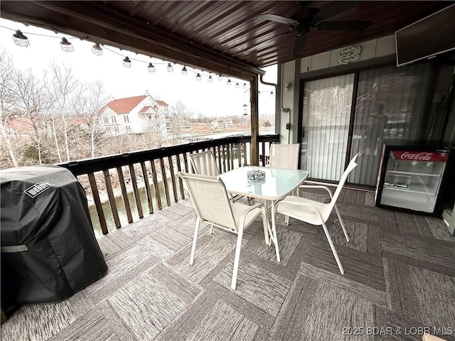 wooden deck with area for grilling and ceiling fan