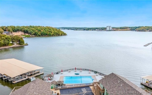 birds eye view of property with a water view