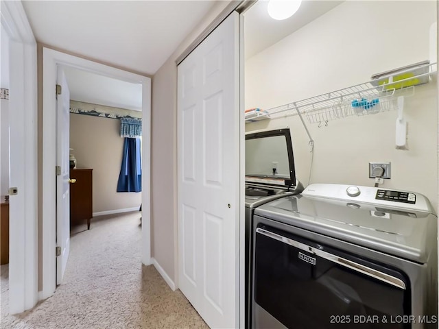 laundry room with light colored carpet and washer and clothes dryer