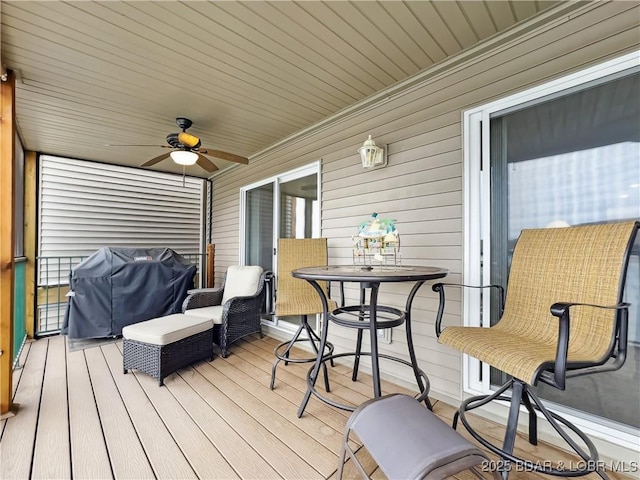 deck with area for grilling and ceiling fan