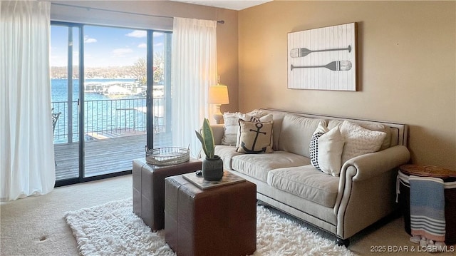 living room with a water view and light colored carpet