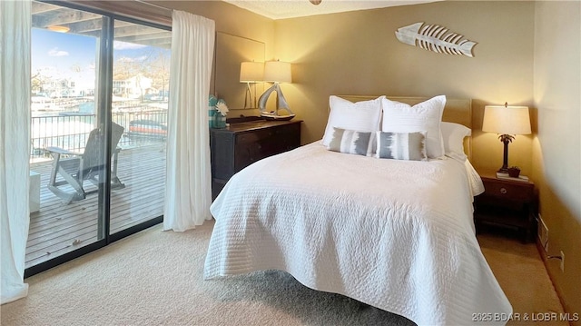 bedroom featuring multiple windows, carpet floors, and access to outside