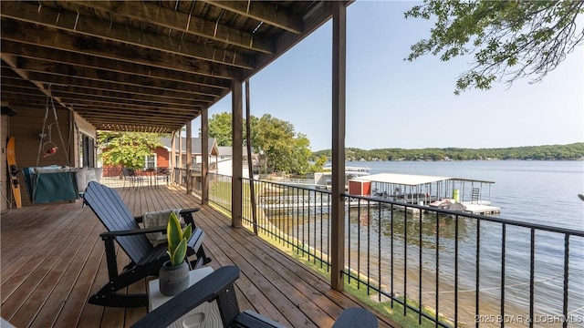 wooden terrace featuring a water view