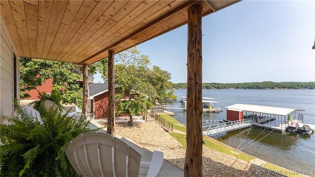 view of patio / terrace featuring a water view and a boat dock