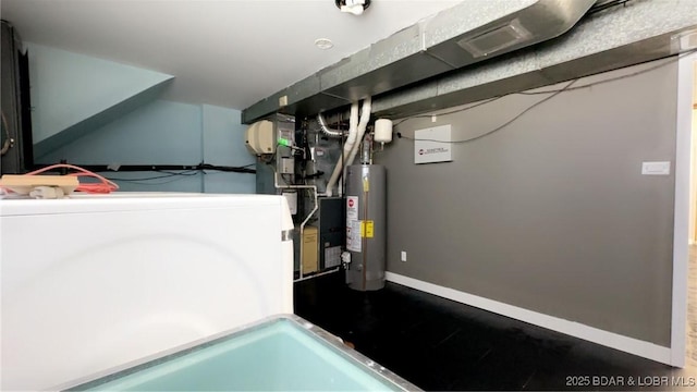 utility room with water heater and washer / dryer