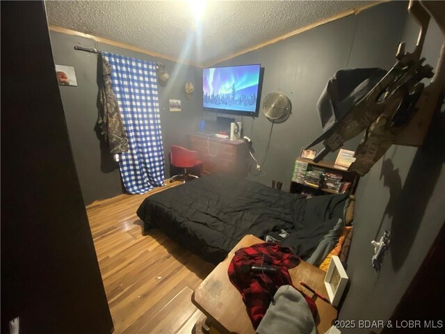 23417 Hwy Tt, Versailles, MO 65084 - bedroom with a textured ceiling, lofted ceiling, and wood finished floors