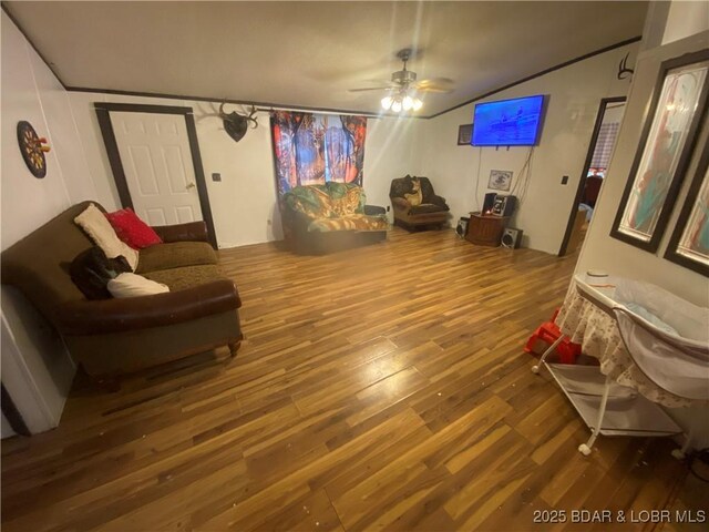 23417 Hwy Tt, Versailles, MO 65084 - living area featuring wood finished floors, vaulted ceiling, and a ceiling fan