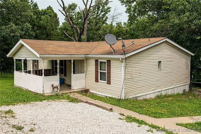 23417 Hwy Tt, Versailles, MO 65084 - view of front of house featuring a porch and a front lawn