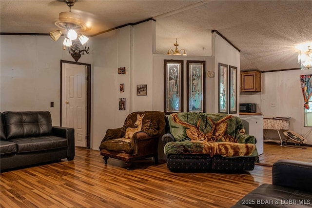 23417 Hwy Tt, Versailles, MO 65084 - living area featuring wood finished floors, ceiling fan, a textured ceiling, a chandelier, and ornamental molding