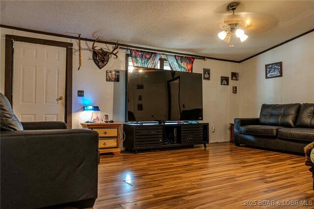 23417 Hwy Tt, Versailles, MO 65084 - living area with a ceiling fan, wood finished floors, a textured ceiling, and ornamental molding