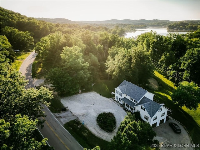 bird's eye view with a water view and a view of trees