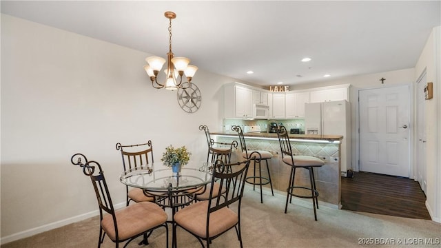 316 Cedar Heights Dr Unit 2C, Camdenton, MO 65020 - dining space with a chandelier, light carpet, baseboards, and recessed lighting