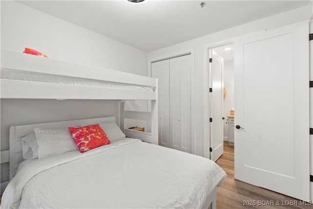 1065 Topsider Ln Unit 408, Osage Beach, MO 65065 - bedroom with light wood-style flooring and a closet